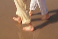 Photo of two people walking on the beach