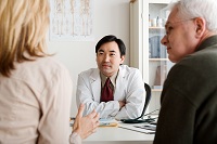 Picture of a middle-aged couple talking with a physician